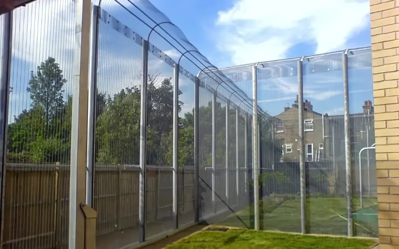 FST flexible security topping on a curved-top polycarbonate panel security fence