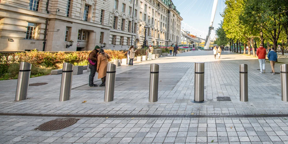 Stainless steel vehicle barrier bollards installed in an urban pedestrian zone for hostile vehicle mitigation